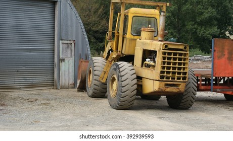 Old digger parked in an engineering yard