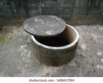 The Old Digging Concrete Water Well (pool) And Its Lid Which Cover By The Dry Moss.