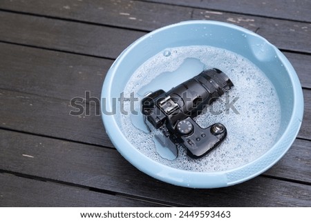old digital camera from 2006 with 6 MP is cleaned for fun in the water