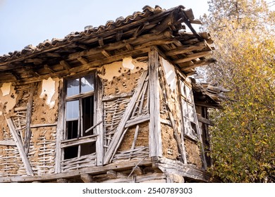 Old dilapidated rural rustic clay wooden house closeup on clear morning day - Powered by Shutterstock