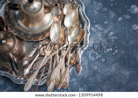 Old dining items (tray, kettle, forks, knives, spoons,) top view 