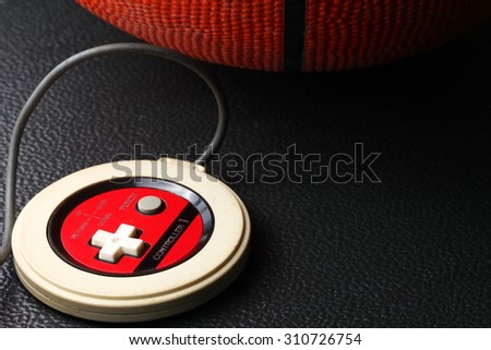 Old and dirty basketball and game controller represent the sport equipment concept related idea.