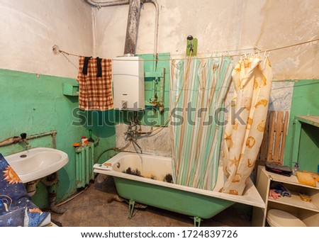 Old and dirty bathroom in the apartment that is prepared to demolition is the place for refugees for temporary period of living and existence
