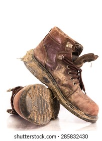 Old And Dirty Boots In Mud. On White Background