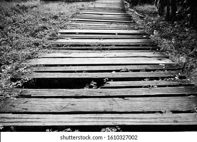old and dirty broken wood bridge on walk way in black and white photography