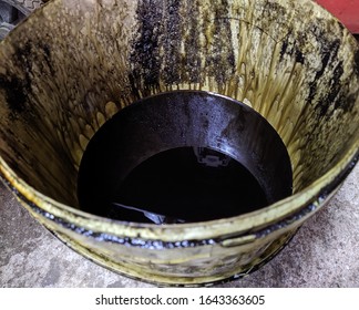 Old Dirty Bucket With Used Engine Oil In The Garage