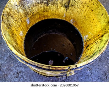 Old Dirty Bucket With Used Engine Oil In The Garage