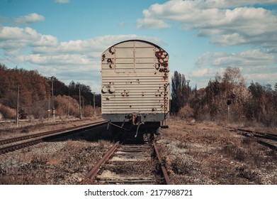 Old dirty carriages of the train stand on the railroad tracks. Photo of train