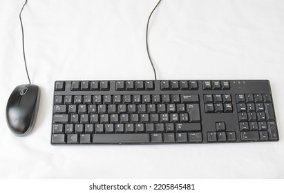 Old Dirty Computer Keyboard Keys And Computer Mouse On A White Surface