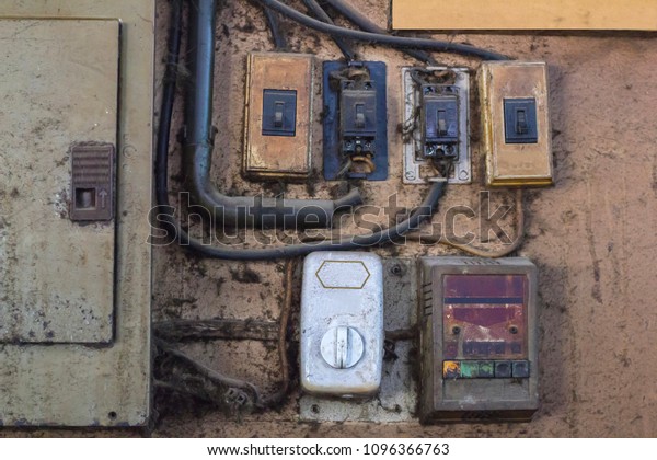 The old and dirty control panel, breaker and\
fan switch,electrics box, black\
wires