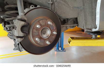 Old And Dirty Disc Brake Waiting For Repairing In Auto Service Area