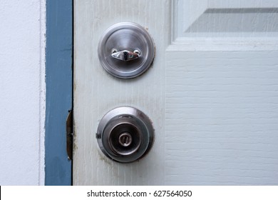 Old And Dirty Door Knob On White Wooden Door.