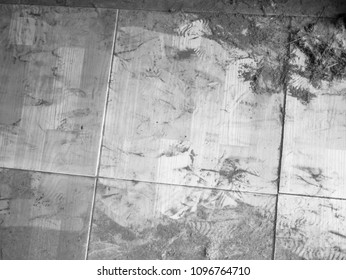 Old dirty floor with cut, foot prints gray color, rough texture and dust background or backdrop with some crack, black frame and space