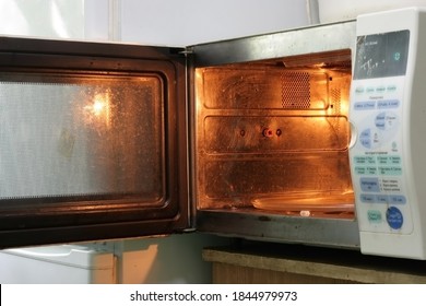 Old Dirty Microwave Oven With Open Door