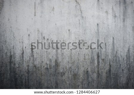 old dirty monochrome background with dripping stain on the wall, detail of texture of black trickle on background, illustration of painted concrete old wall with dirty stain black and white color