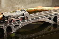 An Old And Dirty Plastic Japanese Steam Train Toy Model On Bridge Model Scenery Represent The Train Toy  For Hobby And Collection Concept Related Idea.