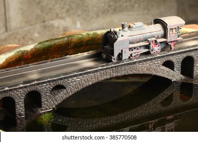 An Old And Dirty Plastic Japanese Steam Train Toy Model On Bridge Model Scenery Represent The Train Toy  For Hobby And Collection Concept Related Idea.