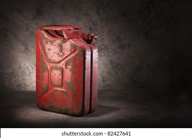 Old, Dirty And Rusty Red Jerry Can Fuel Container.
