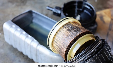 Old Dirty Solar Oil Filter. Closeup Of Diesel Fuel Filter With A Deteriorated Black Plastic Cylinder Removed For Replacement. Selective Focus