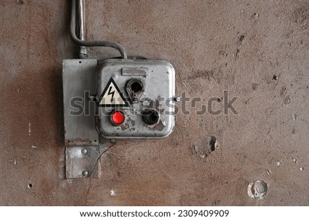 Old dirty switch for on, off and speed control of ceiling fans against a white wall, rough textured wall