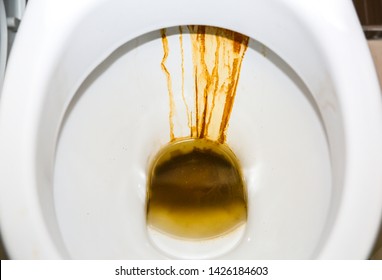 Old dirty toilet bowl. Rust in the bathroom.