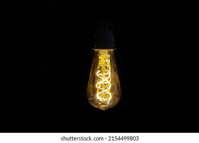 Old Dirty Yellow Orange Lightbulb With Black Background