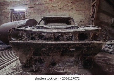 Old disassembled car in an abandoned factory