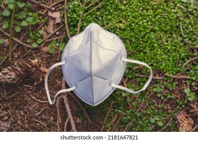 old discarded mask lies on the meadow