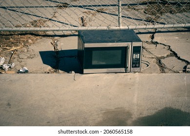 Old Discarded Microwave Oven On Sidewalk