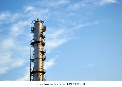 Old Distillation Column Towers With Blue Sky With Clouds Background At Chemical Plant. Exterior Of Silver Metal Rusty Methanol Distillation Enterprise With Copyspace .