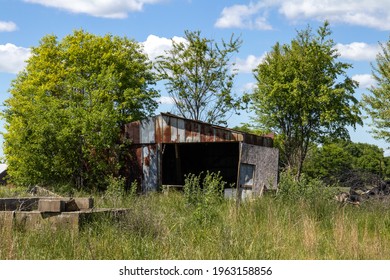 Old Distressed Building On A Overgrown Lot