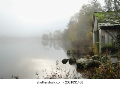 Old disused wooden boat house on the lake side at Lake Grasmere in the Lake District on a misty autumnal morning  - Powered by Shutterstock