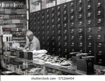 The Old Doctor Of Traditional Medicine Weight Scales China Herbs In Chinese Medicine Shop On Black And White Picture.