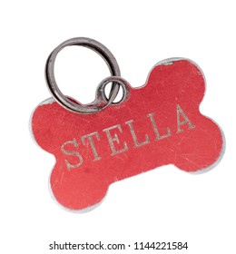 Old Dog Name Tag In Shape Of Bone, Red, With Name Stella. Memento To Remember Deceased Pet, Isolated On White