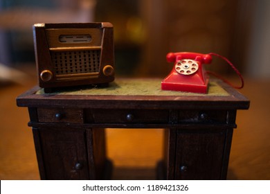 Old Dollhouse Radio And Red Phone On Table