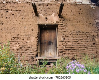 Old Door In An Adobe Wall