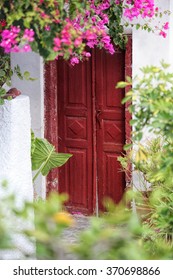 Old Door With Flowers  In Oia Village On Santorini Island, Greece