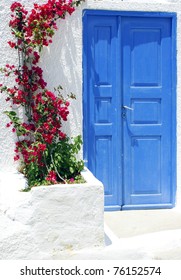 Old Door And Flowers On Santorini Island, Greece