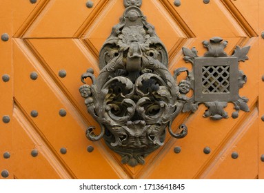 Old door handle. Ancient metal door knocker. Metal Hungarian handle. Vintage texture background.