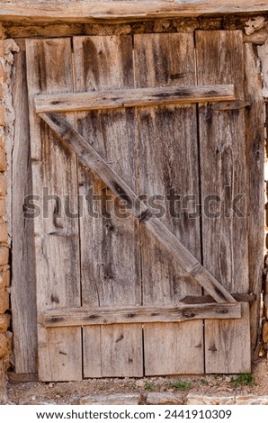 old door made of wooden planks, with iron hinges, beautiful wood textures
