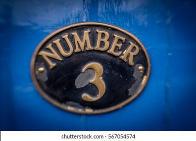 Old Door Plaque With The Number 3 Written On It