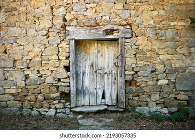 Old Door Of Rural House With Jambs And Wooden Lintel And Stone Wall