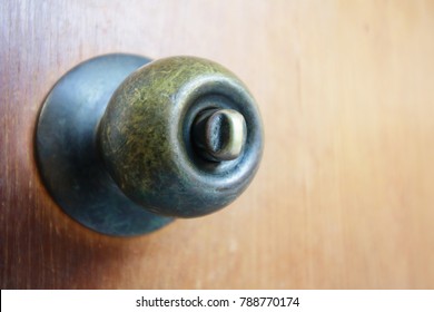 Old Doorknob On Wooden Door