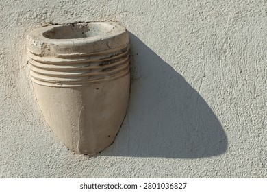 An old drainpipe comming out a facade
