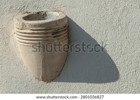 An old drainpipe comming out a facade