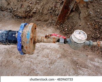 Old Drink Water Pipe, Hydrometer And  Shut-off Valve 
On  Plastic Tube. Repairing Of Drink Water System. Open Excavation Pit. Extreme King Of Corrosion.