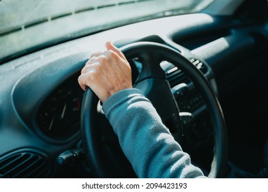 Old Driver Hands Holding Steering Wheel Driving A Car. Learning To Drive A Car. Safety Drive. Learning New Hobby, Habit And Skill For This New Year. Elderly Person Approving The Driving License.