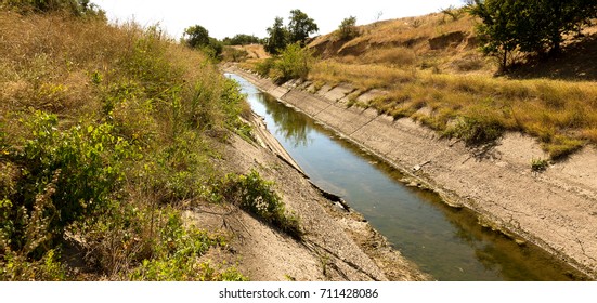 An Old Drying Up Irrigation Channel With Remains Of Water At Bottom Of Canal. Blockade Of Water Irrigation Artery Of Crimea. Artificial Drought, Destruction, Collapse In Irrigated Agriculture