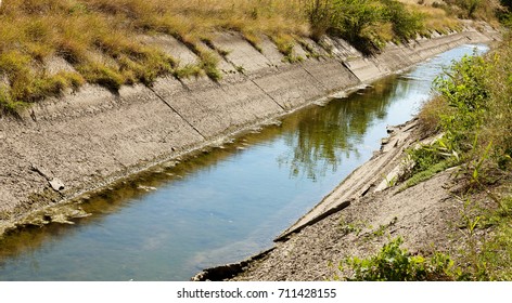 An Old Drying Up Irrigation Channel With Remains Of Water At Bottom Of Canal. Blockade Of Water Irrigation Artery Of Crimea. Artificial Drought, Destruction, Collapse In Irrigated Agriculture