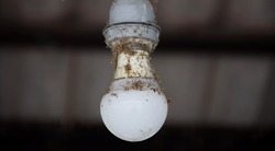 Old Dusty Light Bulb In Power Off.
